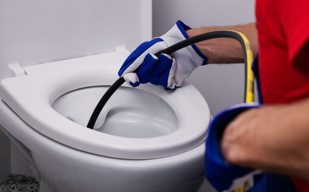 Topnotch Sewer technician performing drain cleaning